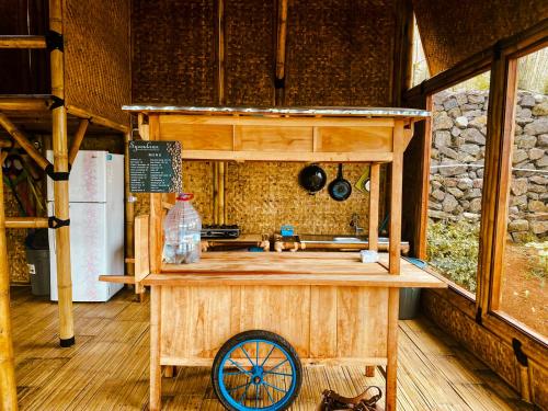 a wooden kitchen with a sink in a room at Saung Arjuna Syandana Resort in Ciwidey