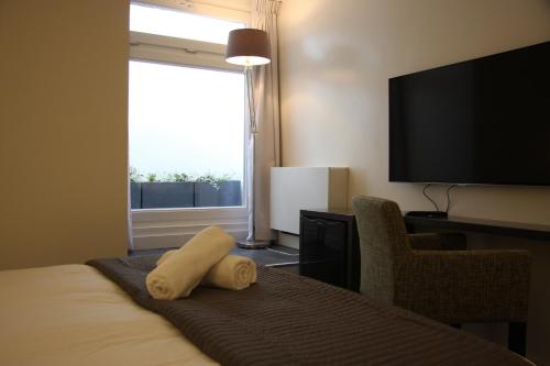 a hotel room with a bed and a large window at B&B Keizers Canal in Amsterdam