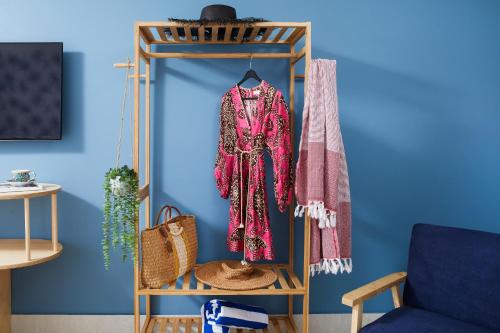 a room with a wooden shelf with clothes at Tessa's on the Beach in Gold Coast