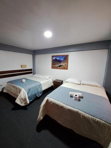 a hotel room with two beds in a room at Hotel Alpamayo Guest House in Huaraz