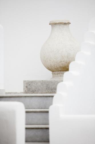 a white vase sitting on top of some stairs at Athina Studios and Suites Plaka in Plaka