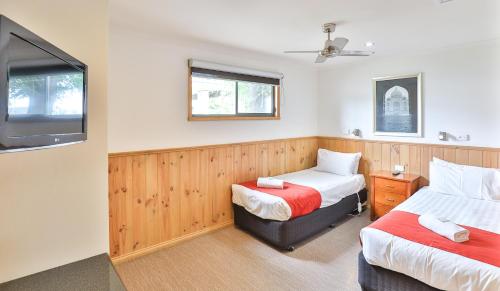 1 dormitorio con 2 camas y TV. en BIG4 Mildura Getaway, en Mildura