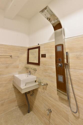 a bathroom with a sink and a mirror at Gold Crown Residence in Dambulla