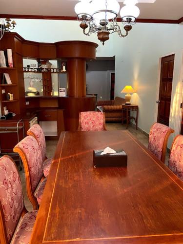 a dining room with a wooden table and chairs at Let's Chill Pool Villa Pattaya Najomtien42 and Sattahip in Ban Tao Than