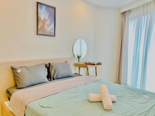 Ένα ή περισσότερα κρεβάτια σε δωμάτιο στο Milan Homestay - The Song Vung Tau Apartment