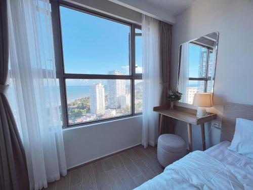 Ένα ή περισσότερα κρεβάτια σε δωμάτιο στο Milan Homestay - The Song Vung Tau Apartment