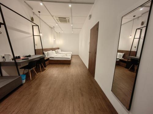 a room with a couch and a table and a mirror at Kangsar Inn 73 in George Town