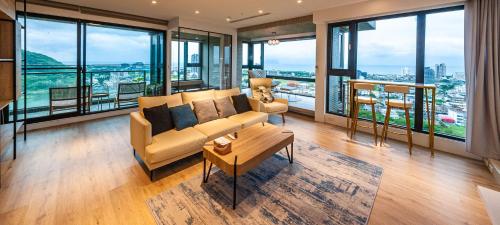 a living room with a couch and a table at 漫遊小旅泳池溫泉宅 Roaming Travel Hot Spring Homestay in Toucheng