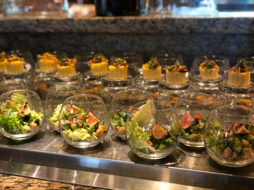 a buffet line of appetizers and salads in glass dishes at Sheraton Grand Bengaluru Whitefield Hotel & Convention Center in Bangalore