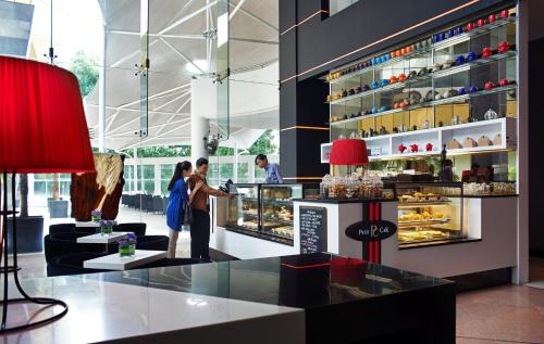 two people are standing in a pastry shop at Wyndham Grand Bangsar Kuala Lumpur in Kuala Lumpur