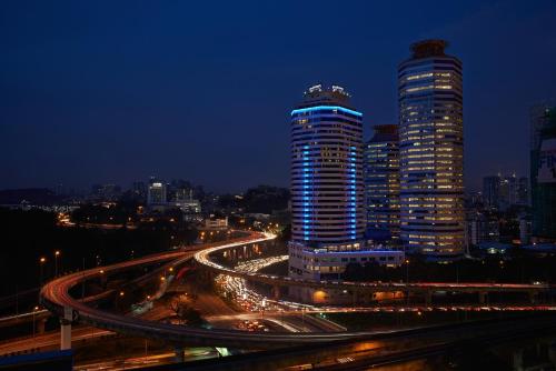 a night view of a city with buildings and traffic at Wyndham Grand Bangsar Kuala Lumpur in Kuala Lumpur