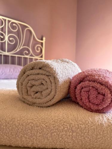 un mucchio di asciugamani seduti sopra un letto di Le sorelle gemelle B&B a Teramo