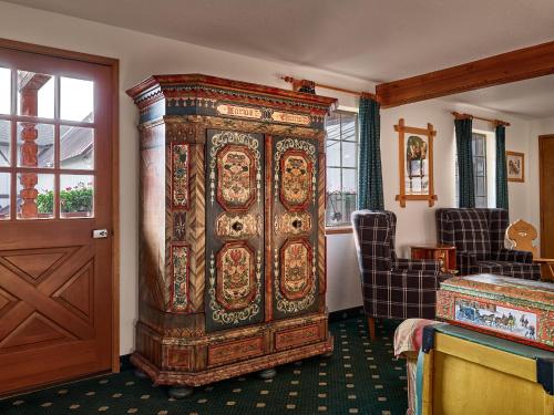 a large wooden cabinet in the corner of a room at Hotel Pension Anna in Leavenworth
