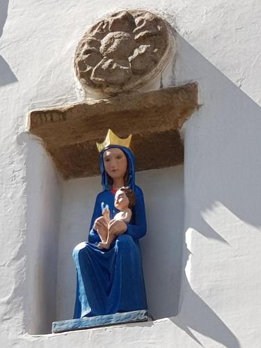 a statue of a woman sitting on a cross at Modrá růže Třeboň in Třeboň