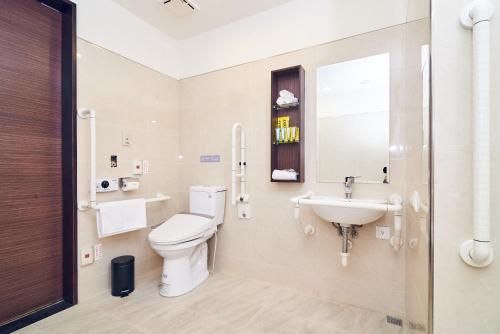 a bathroom with a toilet and a sink at CHECK inn Select Taipei Nangang in Taipei