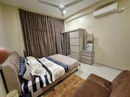 a bedroom with a bed and a couch at Eid2 SKS Habitat Larkin-3BR Family Friendly up to 10Pax - 9 Beds- Free Wifi Pool Parking Gym & Preminum facilities in Johor Bahru