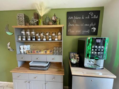 a coffee shop with a coffee machine on a shelf at Europa Hotel City in Saarbrücken