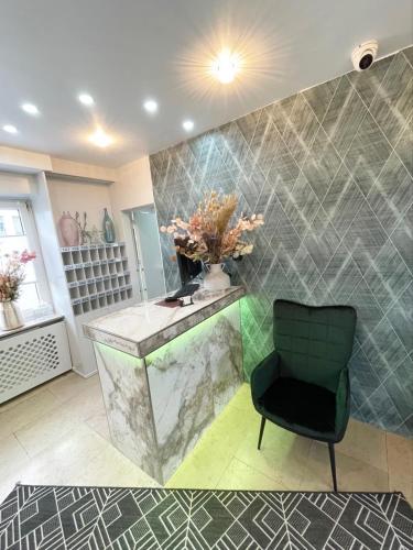 a bathroom with a counter and a chair at Europa Hotel City in Saarbrücken