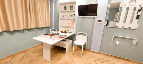 a white table and chairs in a room at Apollo 4 - Luxury Apartment (City Center Studio) in Katerini