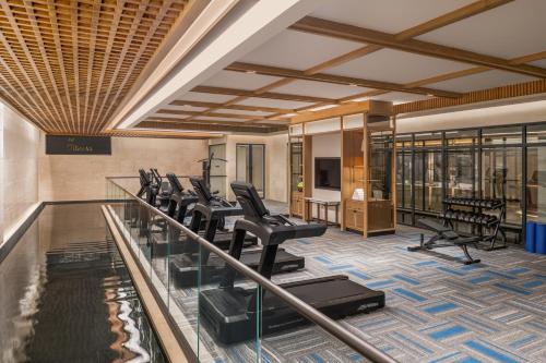 a gym with a row of chairs and a pool at JW Marriott Goa in Vagator
