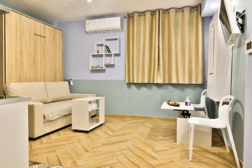 a small living room with a couch and a table at Apollo 4 - Luxury Apartment (City Center Studio) in Katerini