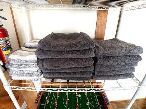 a pile of towels on a drying rack at Higashikawa home in Higashikawa