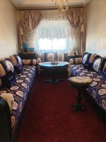 a living room with a couch and a table at Lemssella meknes in Meknès