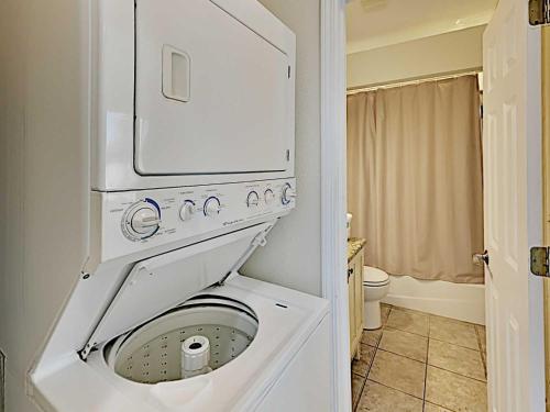 a white washer and dryer in a bathroom at Baywatch #B1 in Pensacola Beach