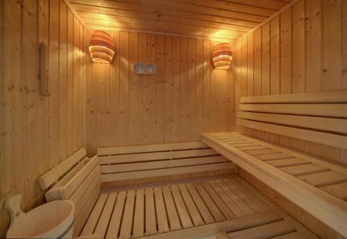 a wooden sauna with a toilet and lights in it at Widokówka Karkonoska - Dom Na Wyłączność in Szklarska Poręba