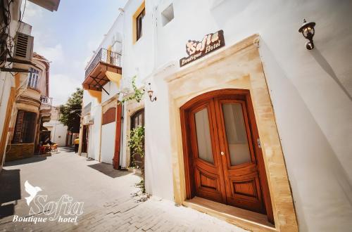 a wooden door on the side of a building at SOFIA BOUTIQUE HOTEL in Kérynia