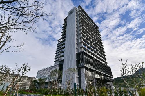 a tall building with many windows on the side of it at Four Points by Sheraton Taipei Bali in Bali