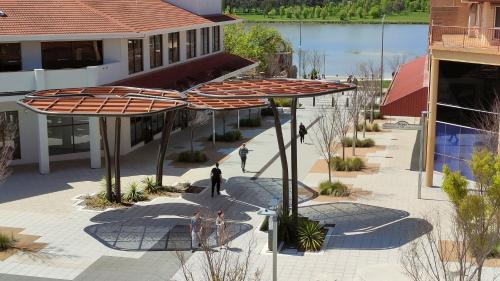 an overhead view of a courtyard with umbrellas at Tuggeranong Short Stay #07 - Sleeps 6 in Tuggeranong