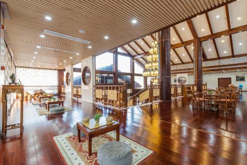 a large room with wooden floors and a large ceiling at S&N Hotel Sanqingshan in Shangrao