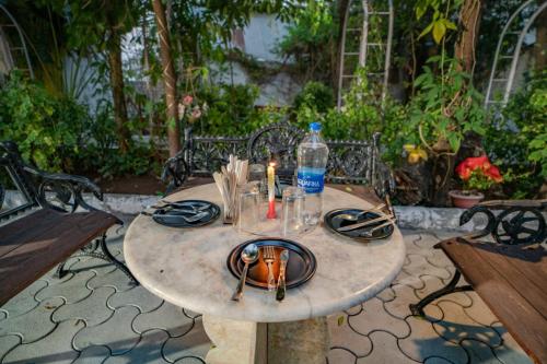 a table with a plate with a candle on it at Hotel Ambavgarh Palace in Udaipur