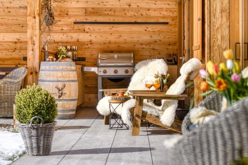 an outdoor patio with a table and a stove at Chalet GM - Gesamtes Haus by A-Appartments in Brand