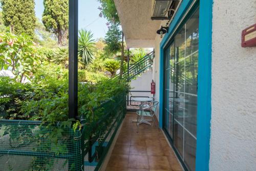 a balcony with a view of a garden at Andromaches large apartment 2 in Achílleion