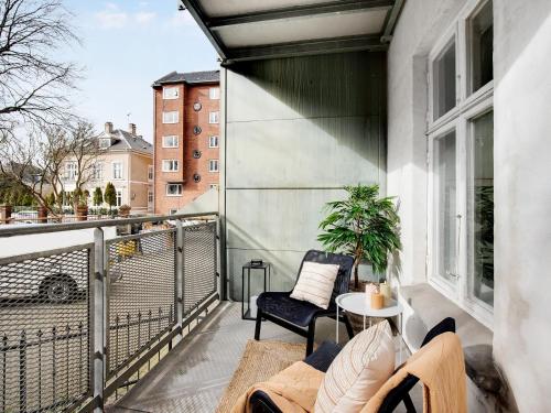 a balcony with a table and chairs on a building at Constantin - Chic 2-Bdr Apt with Balcony in Copenhagen