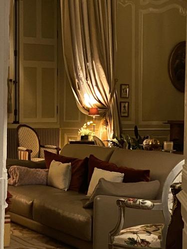 a living room with a couch and a curtain at Château de Bouesse en Berry in Bouesse