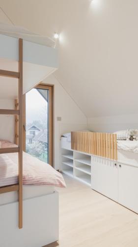 a bedroom with a bunk bed and a window at Holiday House BALE, BALE in Kostel