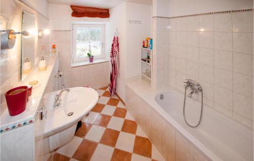 a bathroom with a bath tub and a sink at Ferienwohnung Niederndorferb in Niederndorferberg