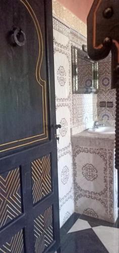 a door to a bathroom with a sink and a sink at Dar LBAHJA 3 in Ouzoud