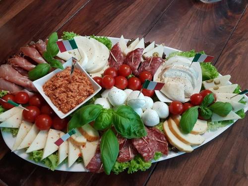 a plate of food with meat and vegetables on a table at AnaCapri Gästehaus Venezia in Ueckermünde