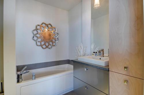a bathroom with a sink and a mirror at Les Immeubles Charlevoix - Le 760-612 in Quebec City