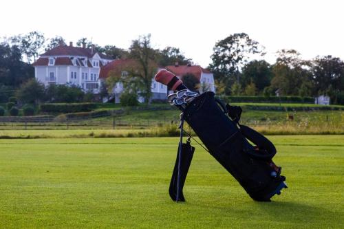 a bag sitting on the grass in a field at Tofta Herrgård in Lycke