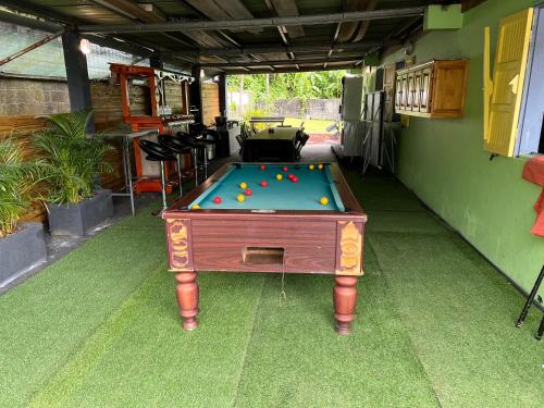 a pool table with balls on it in a garage at Location saisonniere villa l arosatier in Hell-Bourg