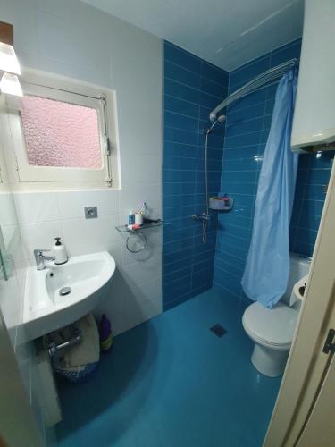 uma casa de banho azul e branca com um WC e um lavatório em Apartament in Benidorm Downtown em Benidorm