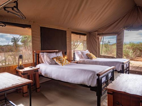 アンボセリにあるTulia Amboseli Safari Campのテント内のベッドルーム1室(ベッド2台付)