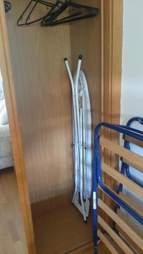 a surfboard hanging on a wall next to a door at TORRE de la FUENTE AprtoVistas Piscina Parking in Oviedo