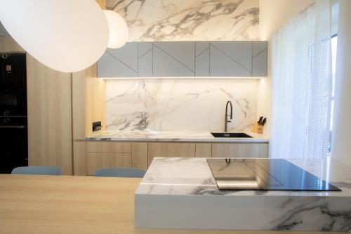 a kitchen with a marble counter top and a sink at Studio Vilawin Kranjska Gora in Kranjska Gora