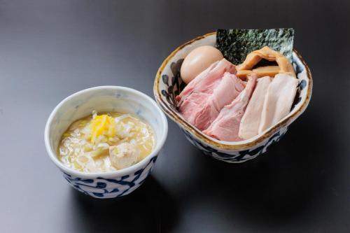 two bowls of food with meat and a bowl of soup at BEB5 Tsuchiura by Hoshino Resorts in Tsuchiura